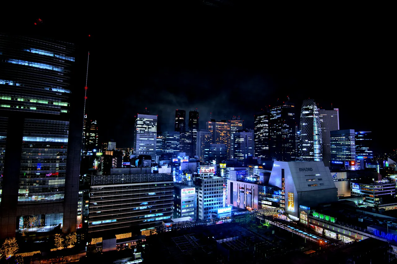 Shinjuku Station area illuminated at night in Tokyo